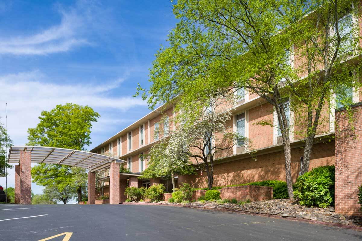 Exterior view of Lakewood Place with trees and landscaping