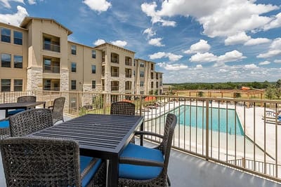 Outdoor pool area with seating and building view