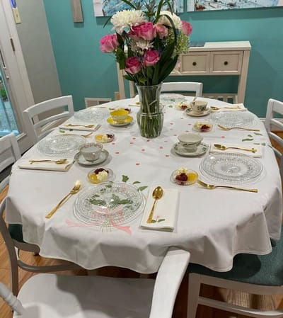 Beautifully set dining table with flowers and china
