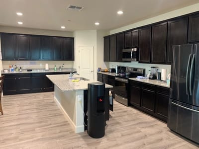 Kitchen area with cabinets, appliances, and countertop
