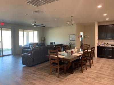 Bright common area with seating and dining table