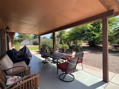Outdoor patio area with seating and greenery