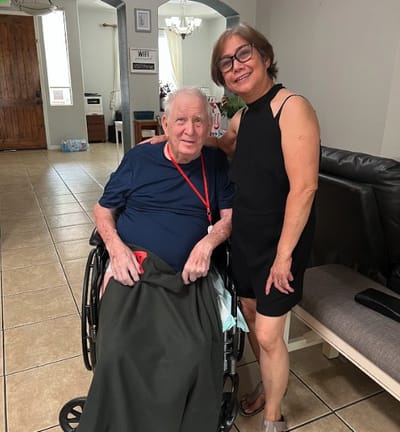 Resident and staff member smiling in a common area