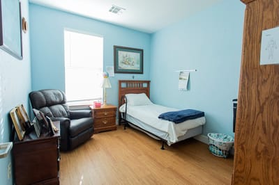 Comfortable private room with a bed and armchair