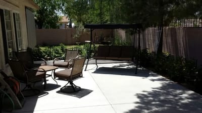 Outdoor patio area with seating and swing