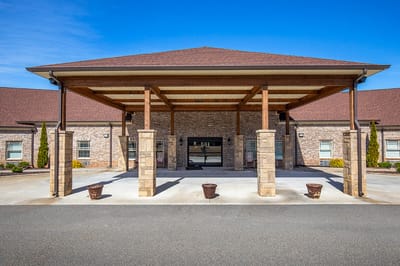 Exterior view of a nursing home entrance with covered porch