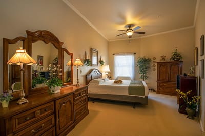 Cozy resident bedroom with warm lighting and furnishings