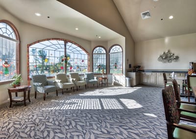 Bright common area with seating and large windows