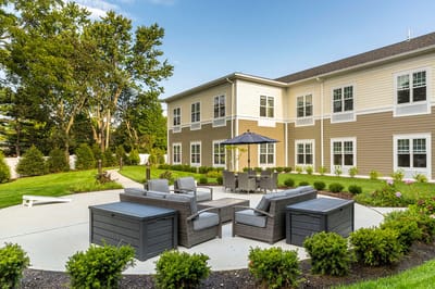 Outdoor seating area with landscaping and building