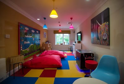 Colorful activity room with bean bags and playful decor