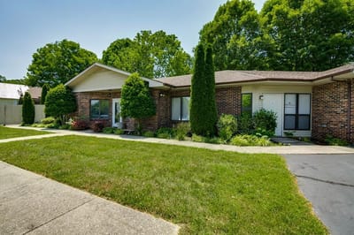 Exterior view of a single-story building with landscaped grounds