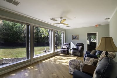 Bright common area with large windows overlooking the garden