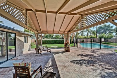 Outdoor area with seating and a pool view