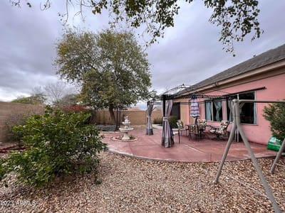 Outdoor patio area with seating and greenery