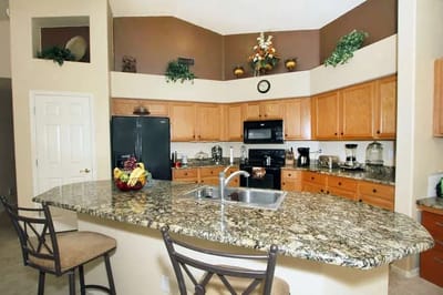 Brightly lit kitchen with granite countertops