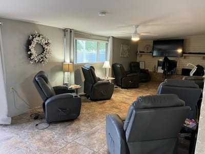 Common area with recliners and light decor
