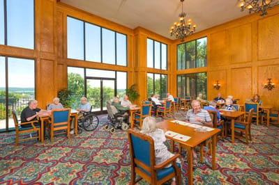 Residents enjoying a bright common area with large windows