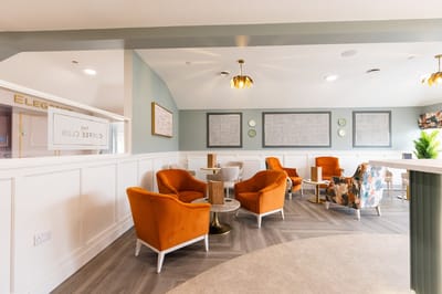 Cozy common area with orange chairs and modern decor