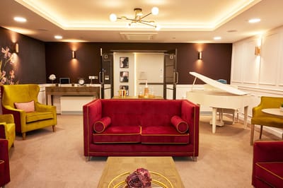 Stylish common area with colorful seating and a piano