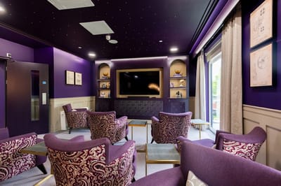 Common area lounge with purple decor and seating