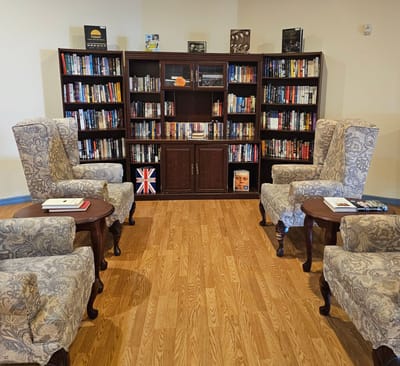 Cozy lounge area with bookshelves and seating