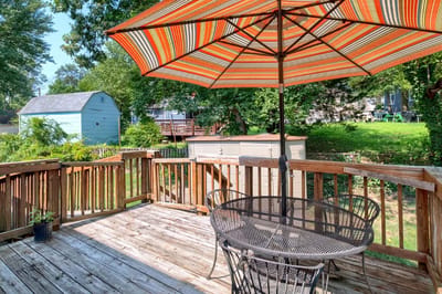 Cozy outdoor deck with a striped umbrella