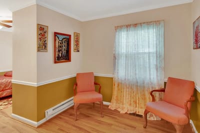 Cozy sitting area with two chairs and wall art