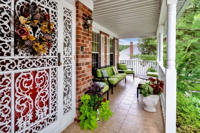 A welcoming porch with seating and colorful decor