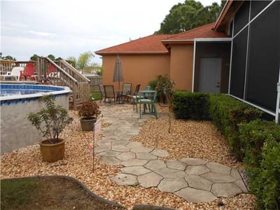Outdoor seating area with plants and a walkway