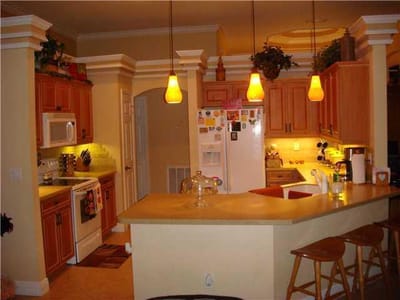 Well-lit kitchen area with cabinetry and appliances
