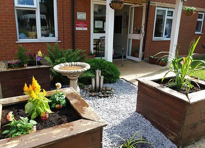 Outdoor garden area with planters and seating