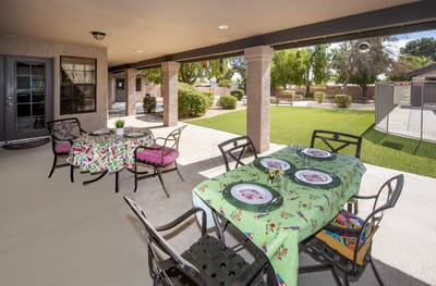 Outdoor dining setup with colorful tablecloths