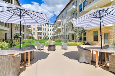 Outdoor seating area with umbrellas and greenery