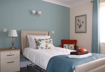 Cozy resident room with floral decor and comfortable seating