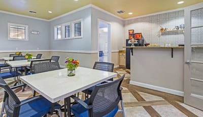 Bright dining room with tables and flowers