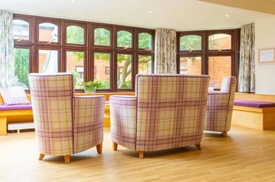 Common area with cozy armchairs and large windows