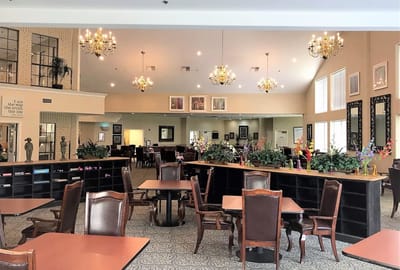 Bright common area with tables and plants