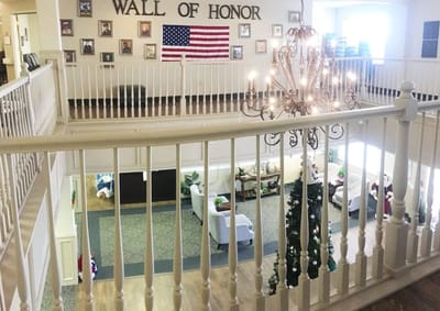 Interior view of a common area with a chandelier and honor wall