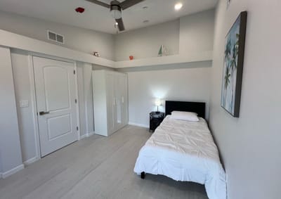 Private room with a bed and closet