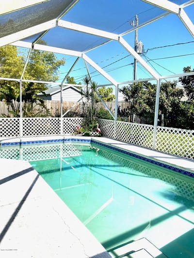 Indoor pool area with screen enclosure and plants