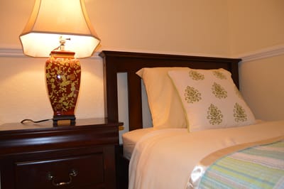 Cozy resident room with bedside lamp and decoration