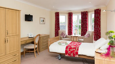 Westbury Court Care & Nursing Home, nursing home — Cozy senior living room with wooden furniture and bright decor