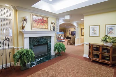 Well-decorated interior common area with a fireplace