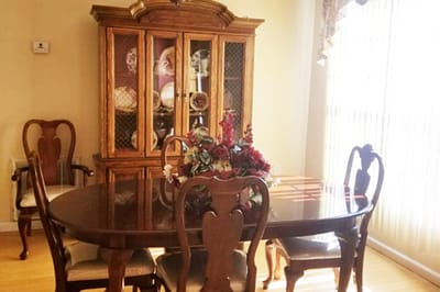 Dining area with a wooden table and china cabinet