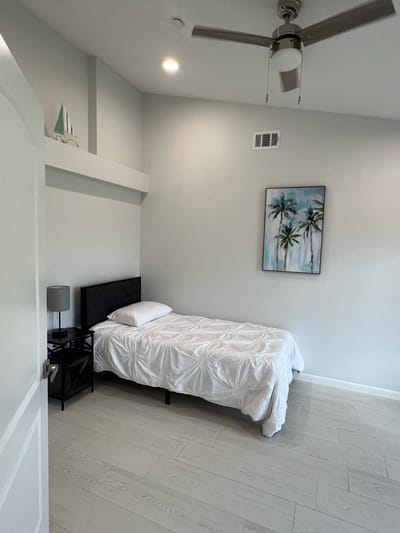 Simple interior room with a single bed and decor