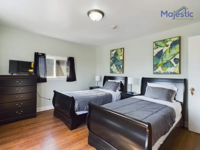 Well-furnished bedroom with twin beds and decor