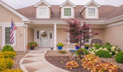Welcoming entrance with flowers and American flag