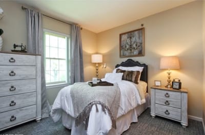 Well-decorated resident bedroom with cozy furnishings.