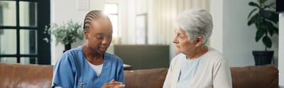 Cherokees Angel Personal Care Home, Nursing Home in Canton, GA — Caregiver conversing with an elderly resident in a cozy setting