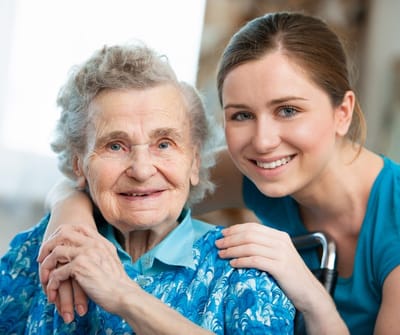 Cherokees Angel Personal Care Home, Nursing Home in Canton, GA — Smiling elderly woman with caregiver in a cozy setting